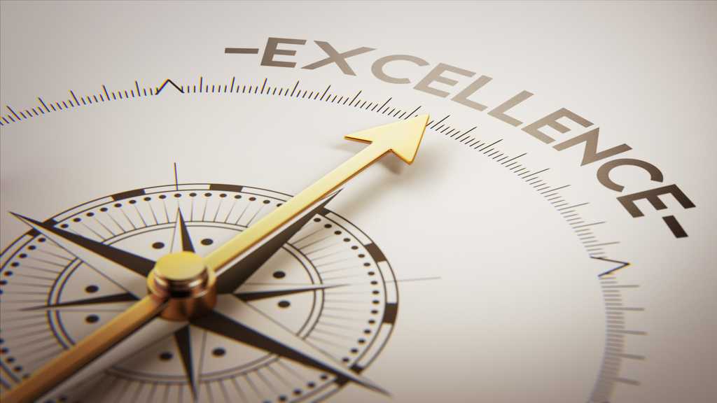 a compass with gold needle pointing to the word excellence.