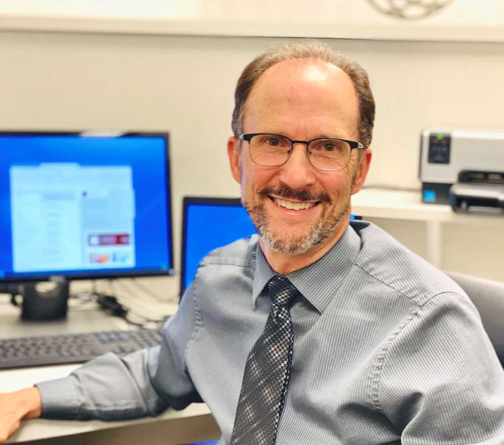 David Stipech at desk