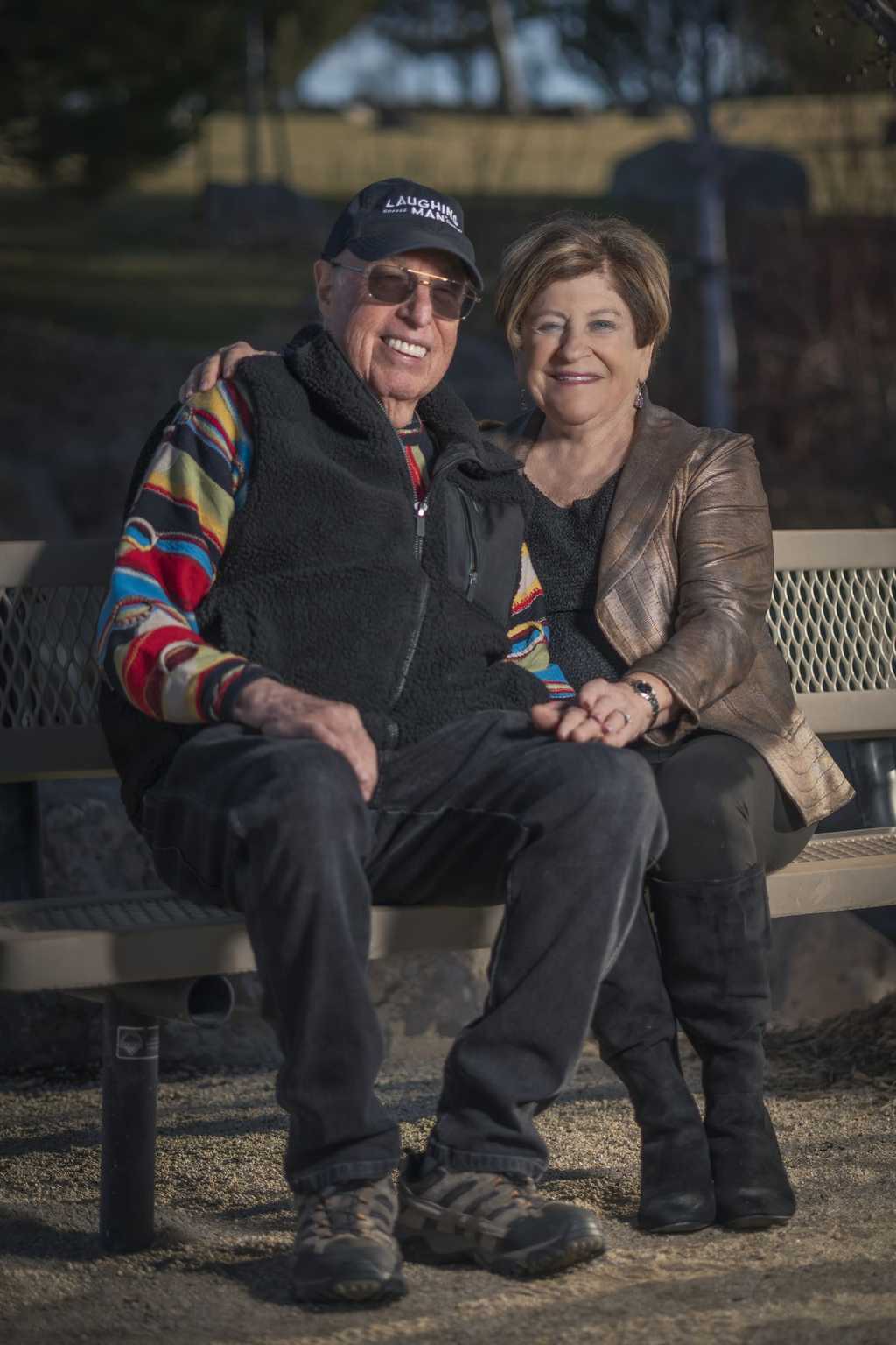 Mark and Carol Steingard sitting on a park bench in ArrowCreek