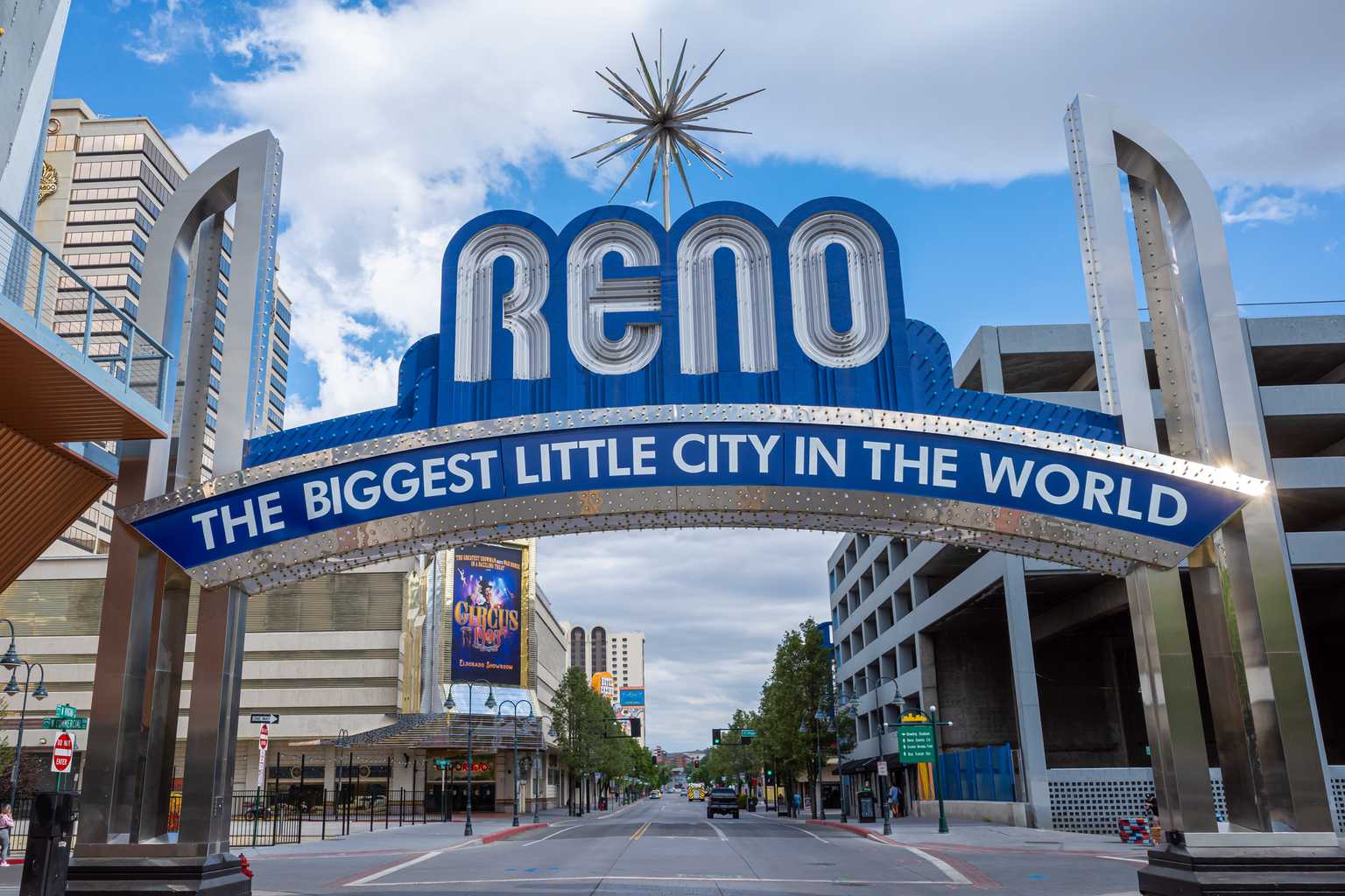 The Reno Arch, blue and silver, spanning Virginia Street in downtown Reno during the daylight hours.