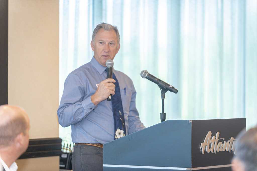 Chris Askin speaks from the lectern to the attendees as the Atlantis during the Aug. 5, 2021 Professional Adviors Council social.